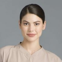 A Woman In A Beige Shirt Confidently Showcasing A Casual Stylish Outfit — Bespoke in Southport, QLD