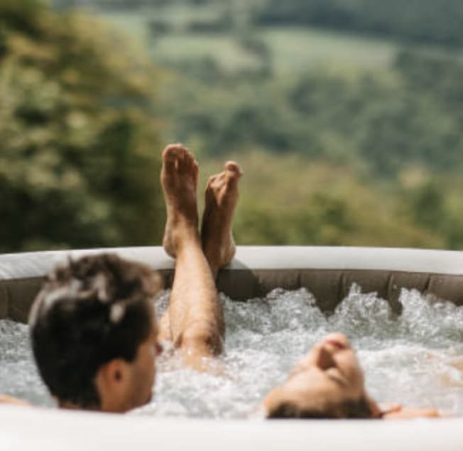 Two Friends Relaxing in An Inflatable Hot Tub in A Serene Outdoor Setting — Bespoke in Southport, QLD