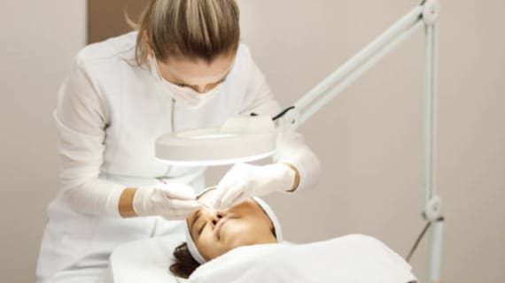 A Woman Receiving Facial Treatment in A Bright, Modern Clinic — Bespoke in Southport, QLD